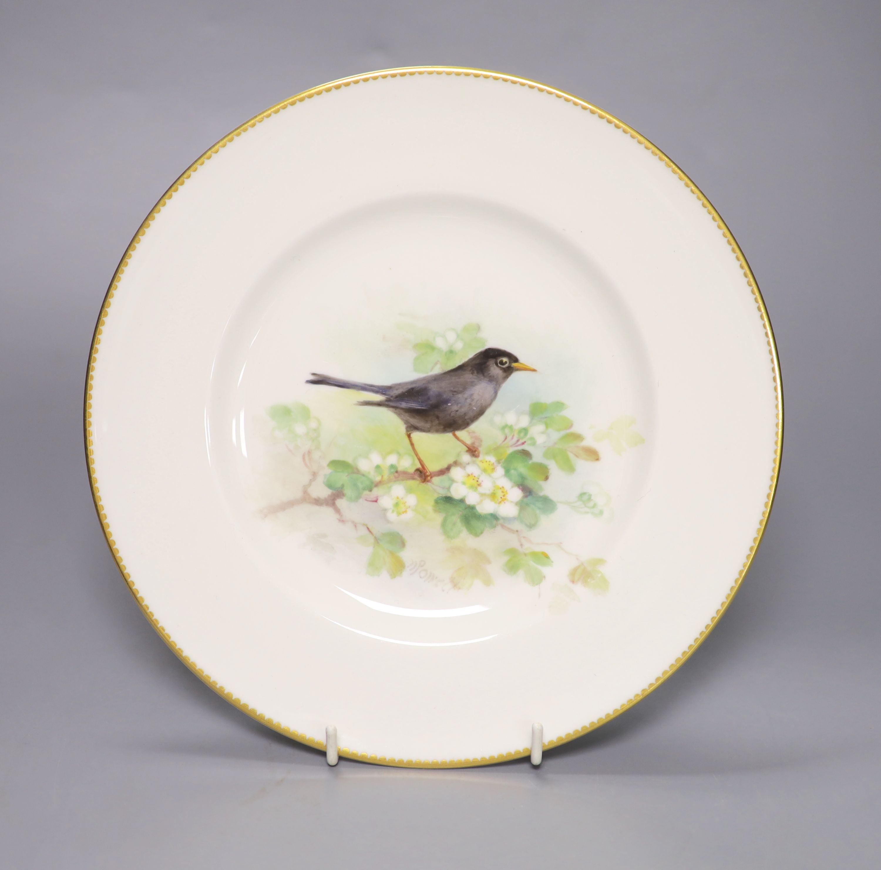 A Royal Worcester plate, painted with a blackbird on a blossoming branch by W. Powell, signed date mark 1939, diameter 23c,